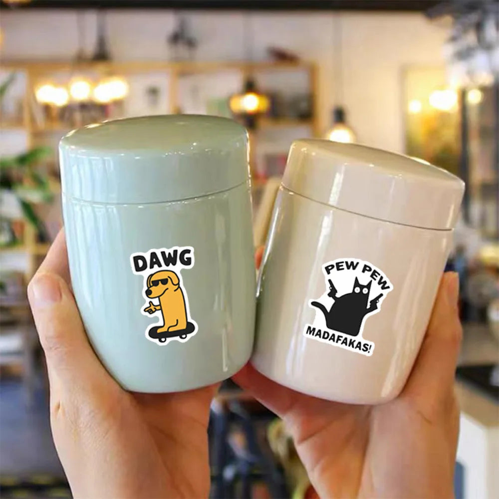 A hand holds a light green and white sticker set featuring a dog meme and a cat meme.