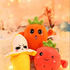 An orange fruit plush toy next to a yellow banana fruit plush toy on a white surface.