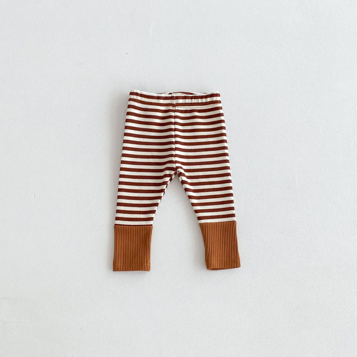 Brown and white striped baby leggings with a tan cuff