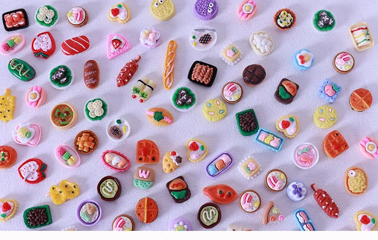 A collection of miniature dollhouse snack foods including candies, jellies, and various small edible items.