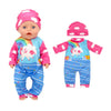 A baby doll wearing a pink hat and a colorful outfit featuring a rainbow and clouds.