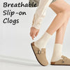 A person wearing beige breathable slip-on clogs with white socks and light trousers.
