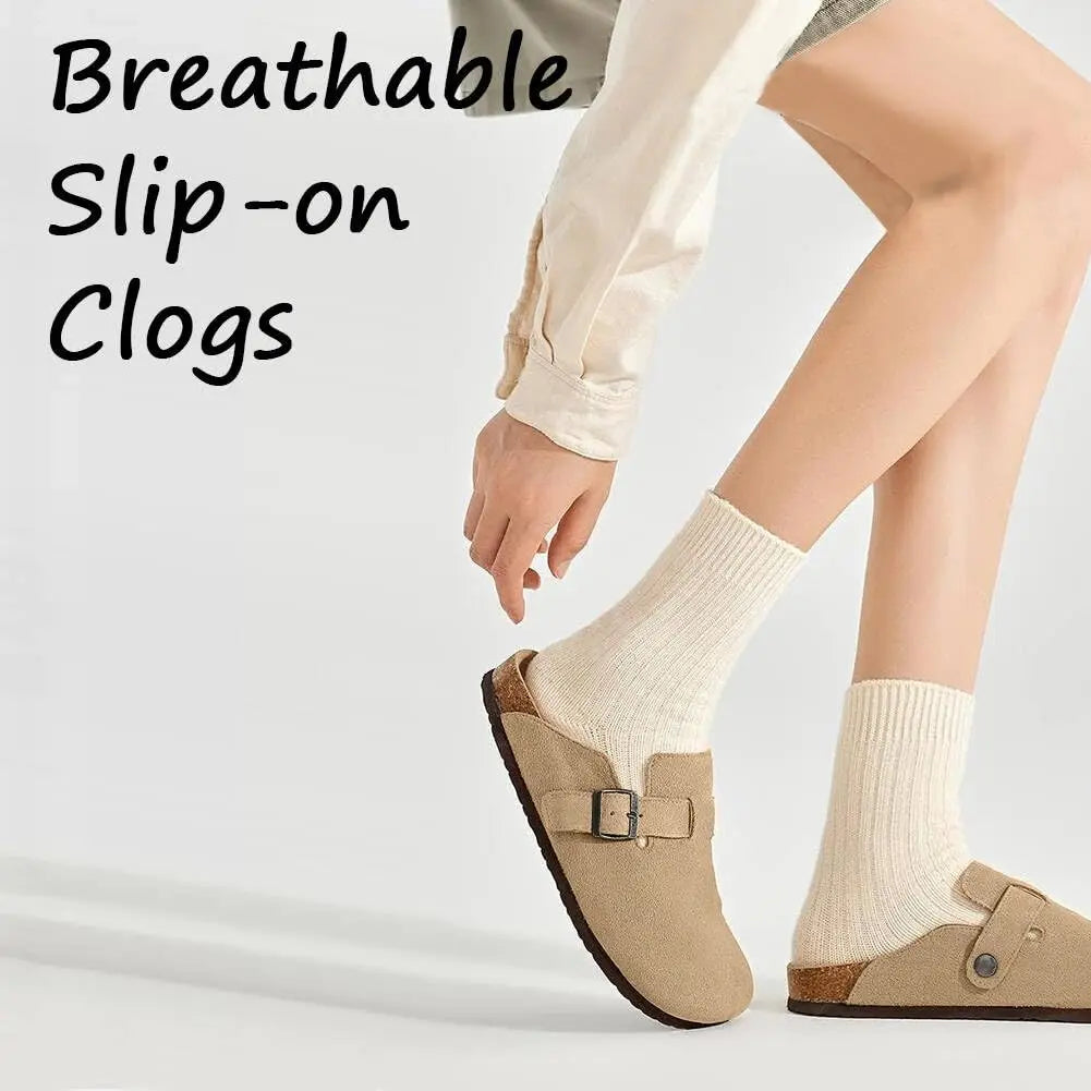 A person wearing beige breathable slip-on clogs with white socks and light trousers.