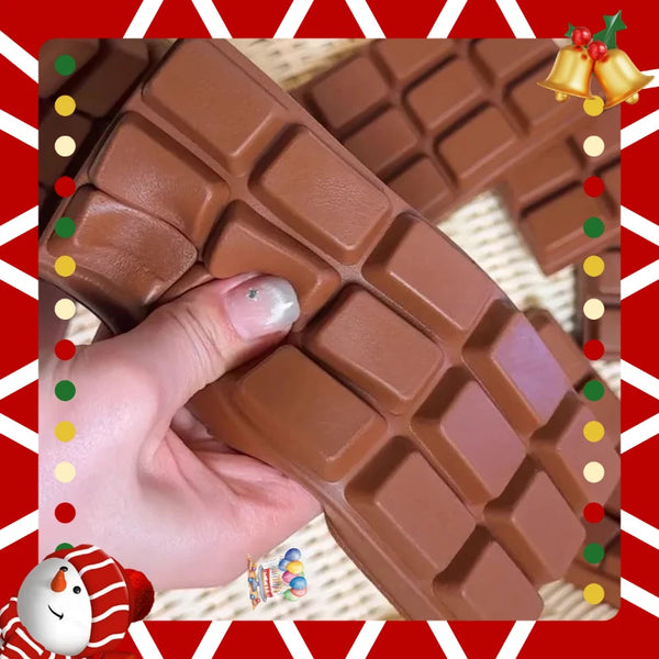 A hand holds a brown chocolate bar fidget toy with a waffle pattern against a red and white background.