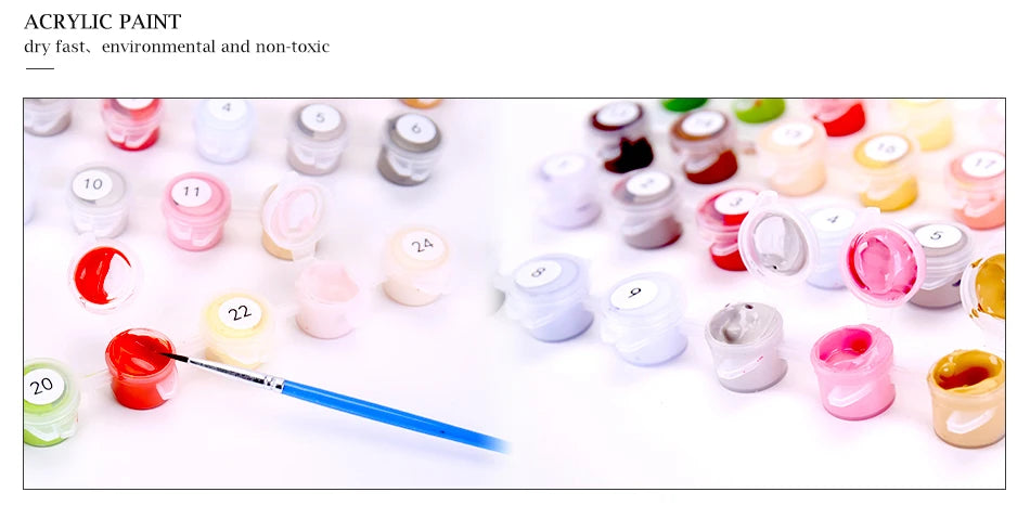 A collection of various acrylic paint colors and brushes laid out for a DIY paint by numbers kit.