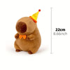 A brown capybara plush toy with a yellow party hat, shown in profile.