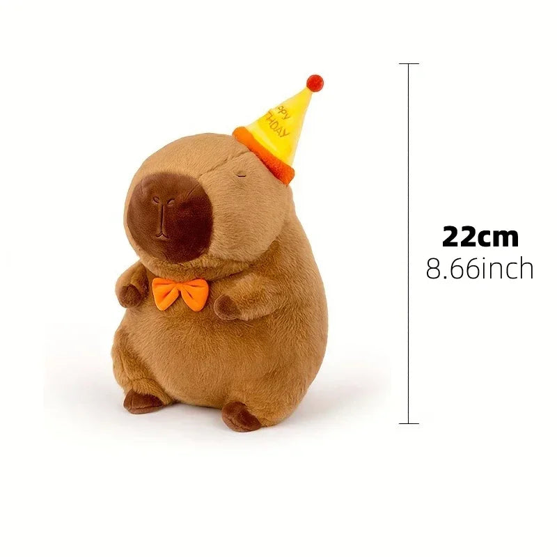 A brown capybara plush toy with a yellow party hat, shown in profile.