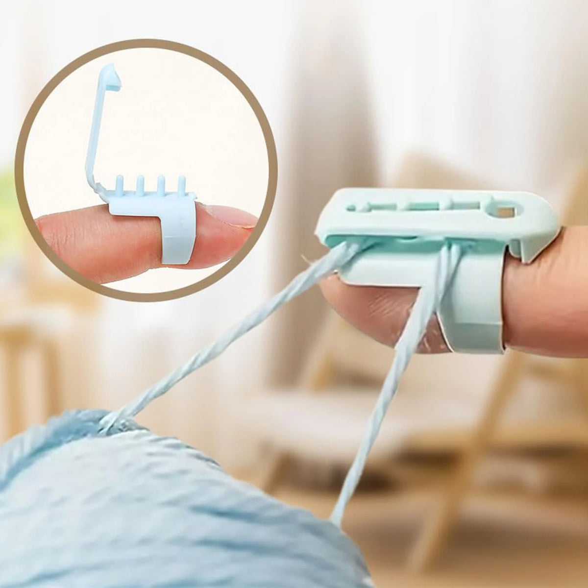 A hand holds a light blue ergonomic yarn guide ring, demonstrating its use for crochet and knitting.
