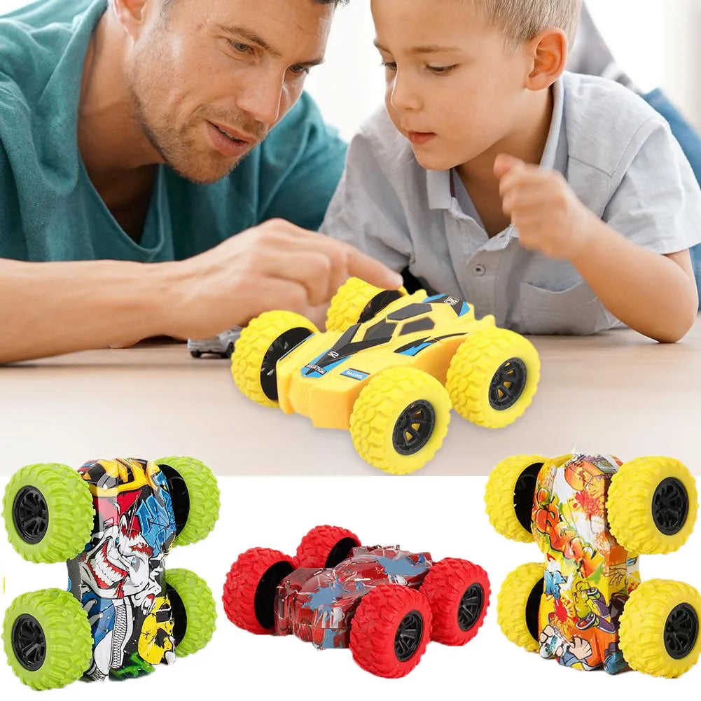 A yellow four-wheel drive stunt car with pull-back action and various colored tires is shown on a table.