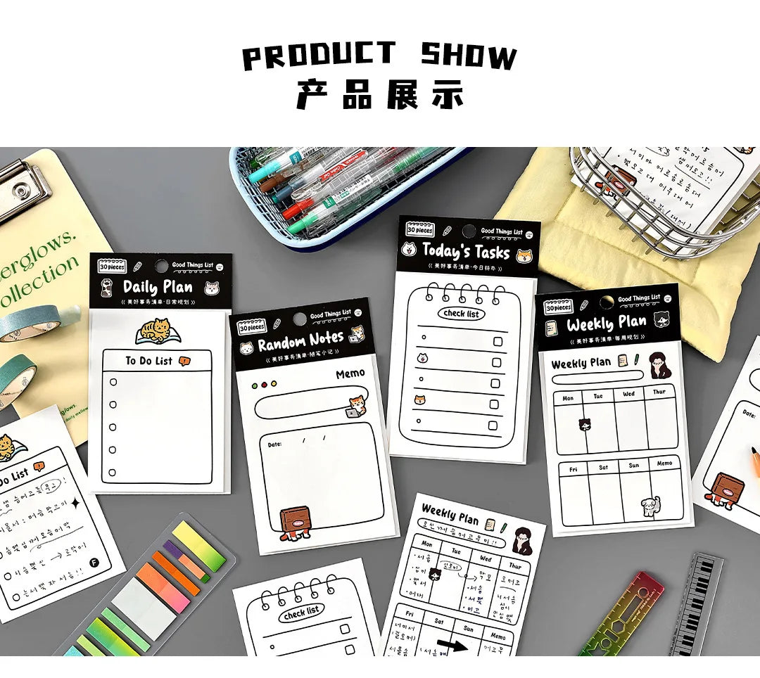 A collection of cute stationery memo pads and planners for daily planning and notes displayed on a gray surface.