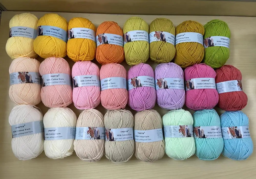 A collection of multicolored soft milk cotton yarn skeins arranged in rows for knitting and crochet projects.