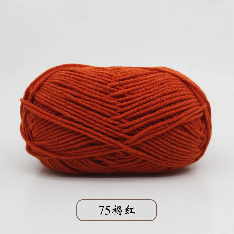 A ball of orange pre-dyed milk cotton yarn, 50g, used for knitting and crochet.