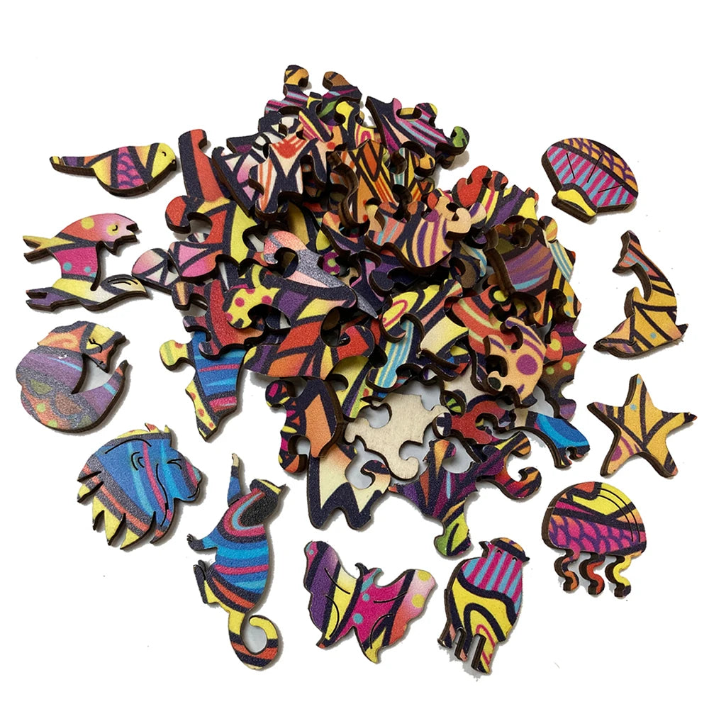A pile of irregular, animal-shaped wooden jigsaw puzzle pieces in various bright colors.
