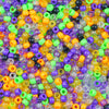A close-up view of a large pile of solid color pony beads in various shades including orange, yellow, green, purple, and blac