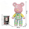 A pink 3D bear building kit made of micro diamond blocks with yellow accents and green details.