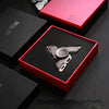 A red box containing a metal luminous fidget spinner is displayed on a dark surface.