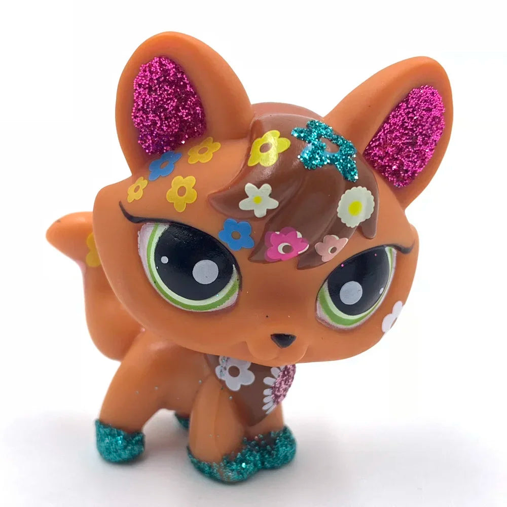 A charming bobble head pet figurine of an orange fox with pink and blue glitter accents.