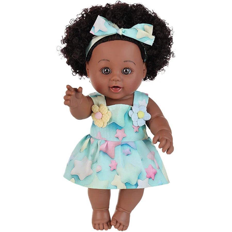 A 12-inch realistic African American baby doll with curly hair wearing a light blue dress and bow