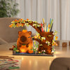 An orange capybara building block pen holder and desk organizer featuring natural wood tones and floral accents.