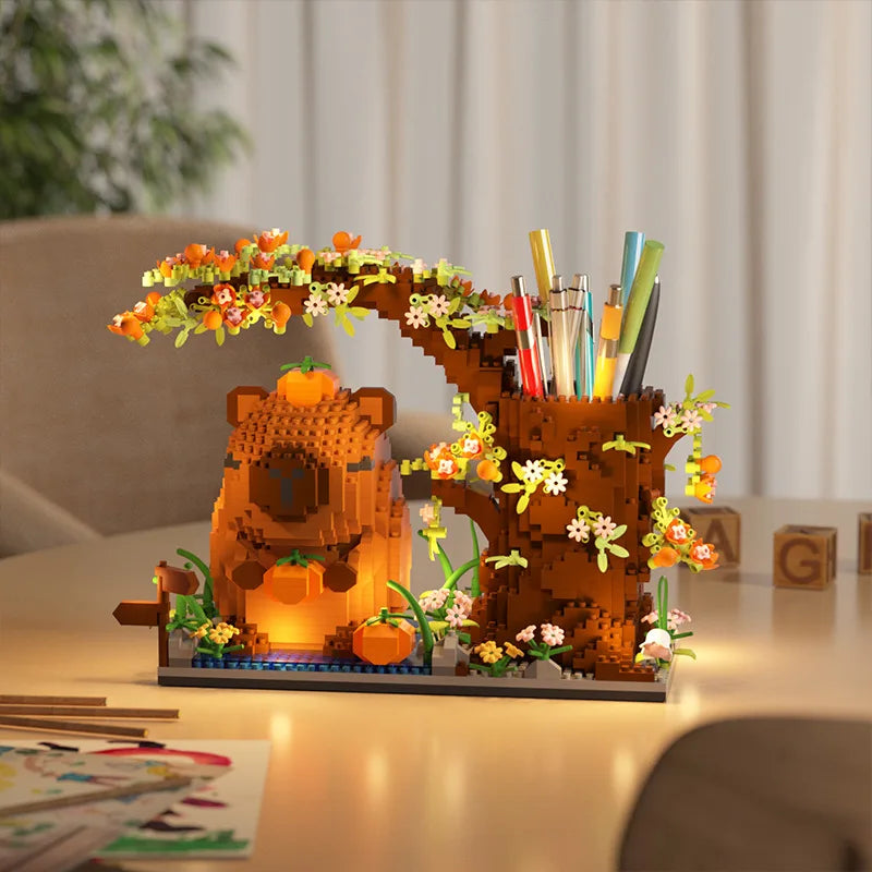 An orange capybara building block pen holder and desk organizer featuring natural wood tones and floral accents.