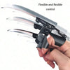 A hand is demonstrating a flexible mechanical wolf claw prop with silver and black components.