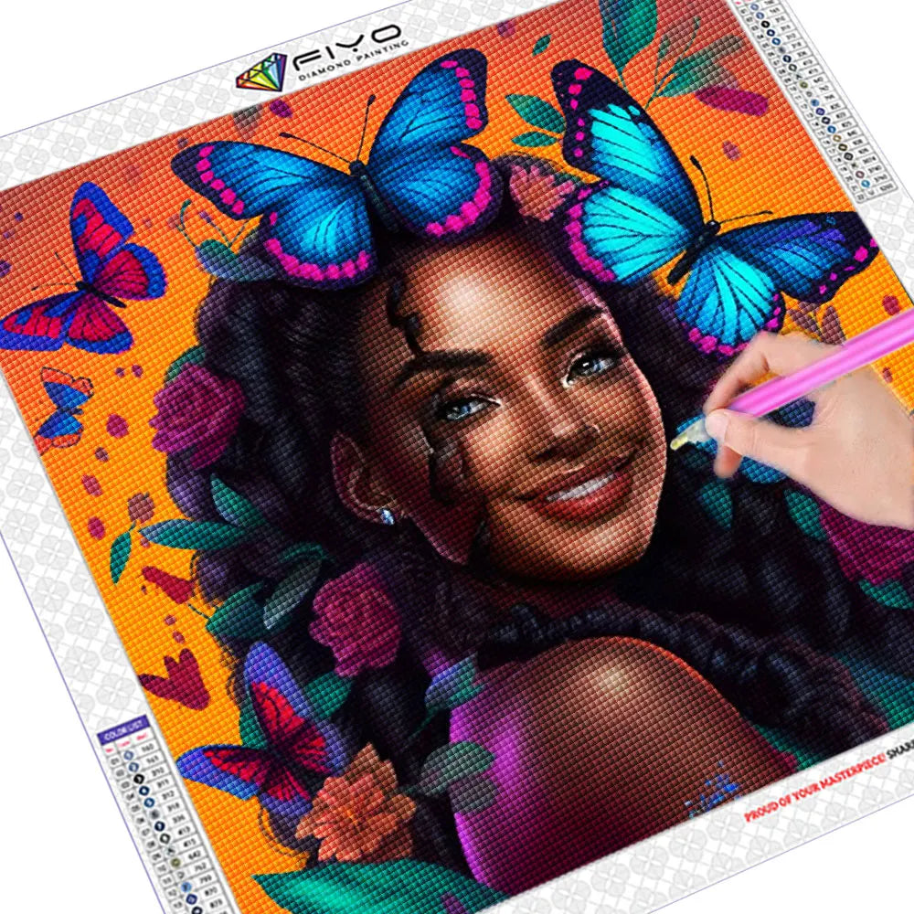 A diamond painting kit featuring a portrait of an African woman with vibrant butterfly accents on an orange background.