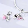 Sterling silver charm bead pendant featuring a car, key, and pink bead on a silver chain.