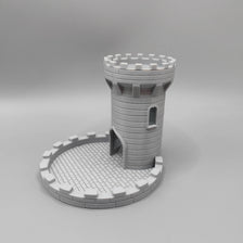 A gray LEGO model of a medieval castle tower with crenellations and an attached tray for tabletop games.