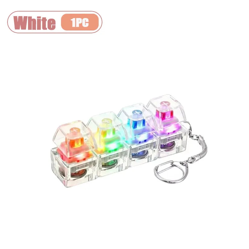 A clear acrylic LED keyboard keycap fidget keychain featuring multiple colored lights.