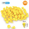 A pile of yellow cardboard construction kit pieces including cutters and tools for kids