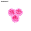 Three pink silicone molds shaped like roses or peonies for resin, jewelry, and baking