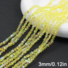 Yellow crystal triangle beads strung together on a white surface