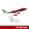 A diecast model of a Malaysia Airlines Boeing aircraft in red and white paint.