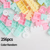 A pile of 256 random colored plastic stacking blocks in various shades of pink, yellow, and mint green.