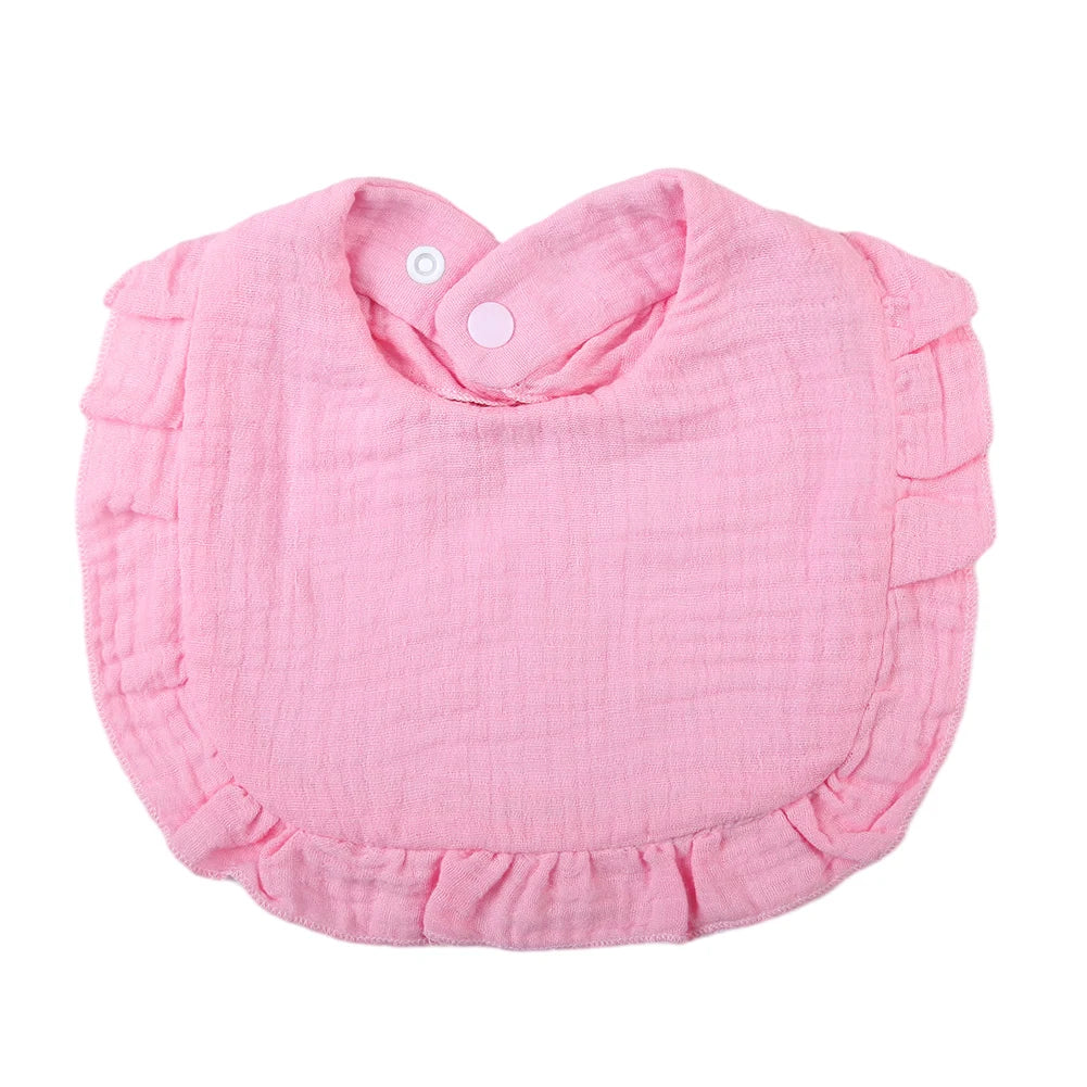 Pink ruffled muslin cotton baby bib with an adjustable snap closure