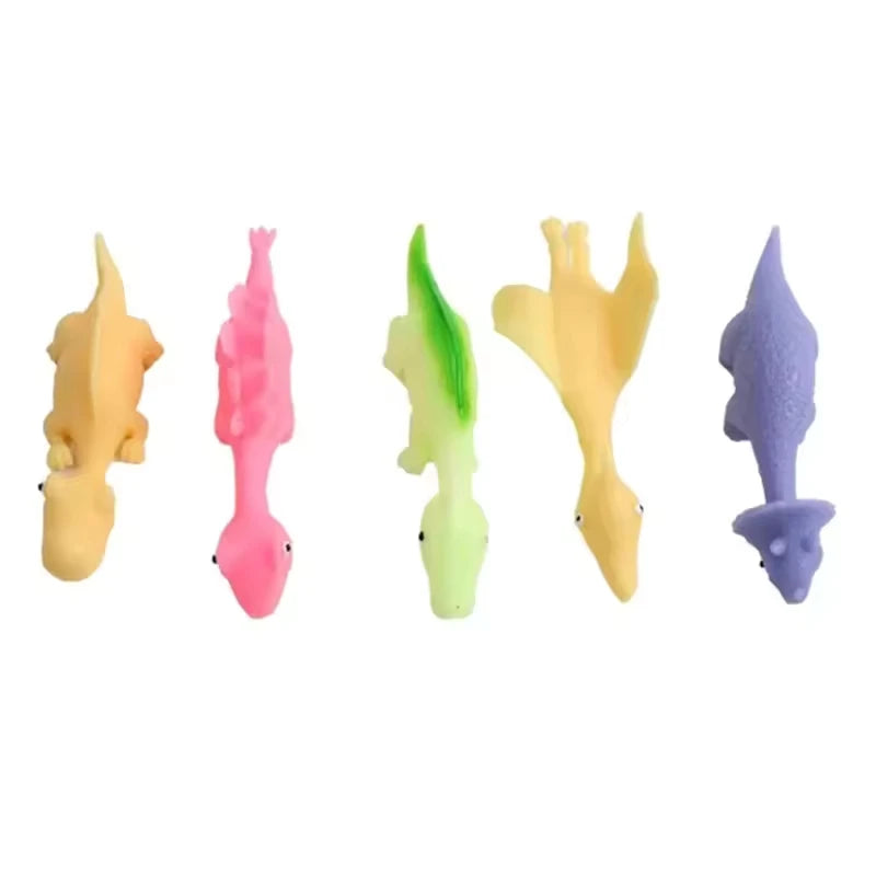 A set of five colored rubber dinosaur slingshot toys in yellow, pink, green, and purple.