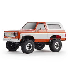 A 1:24 scale Chevrolet K5 Blazer RC crawler truck in orange and white colors.