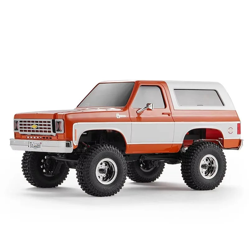 A 1:24 scale Chevrolet K5 Blazer RC crawler truck in orange and white colors.