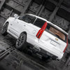 A white 1:32 scale diecast Cadillac Escalade pull-back model car viewed from the rear.