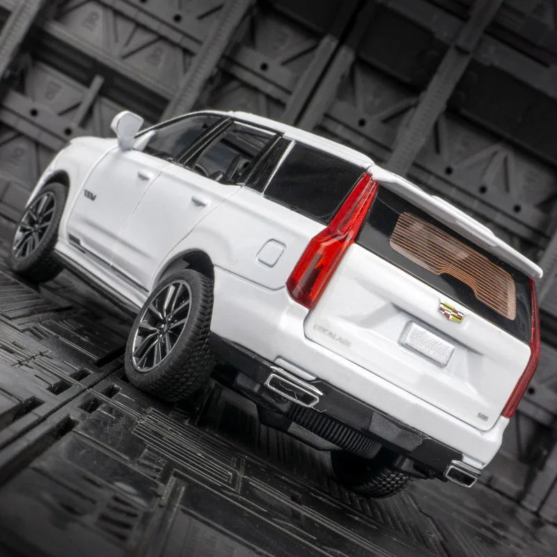 A white 1:32 scale diecast Cadillac Escalade pull-back model car viewed from the rear.