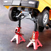 A pair of red metal jack stands are shown supporting the front wheels of a yellow RC crawler vehicle.