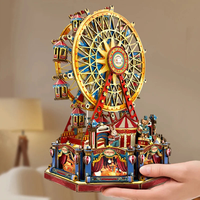 A detailed wooden model kit of a Ferris wheel music box dollhouse featuring colorful structures and figures.