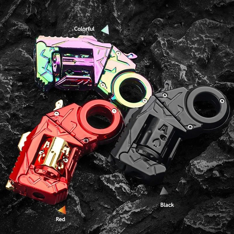 A collection of colorful and black alloy fidget toy guns with shells, displayed on a dark, textured surface.