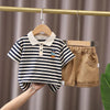 A set of navy and white striped cotton short sleeve t-shirt and shorts for a boy, displayed on a hanger.