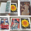 A transparent diamond painting storage album showing several finished floral artwork pieces.