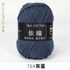 A ball of dark blue milk cotton yarn labeled 76# 灰蓝 for knitting and crochet.