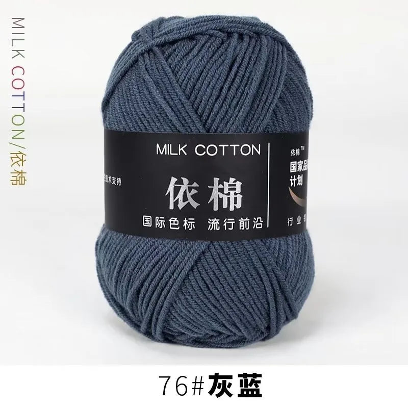 A ball of dark blue milk cotton yarn labeled 76# 灰蓝 for knitting and crochet.