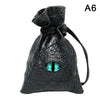Black PU leather drawstring dice bag with an organizer compartment and a green eye design.