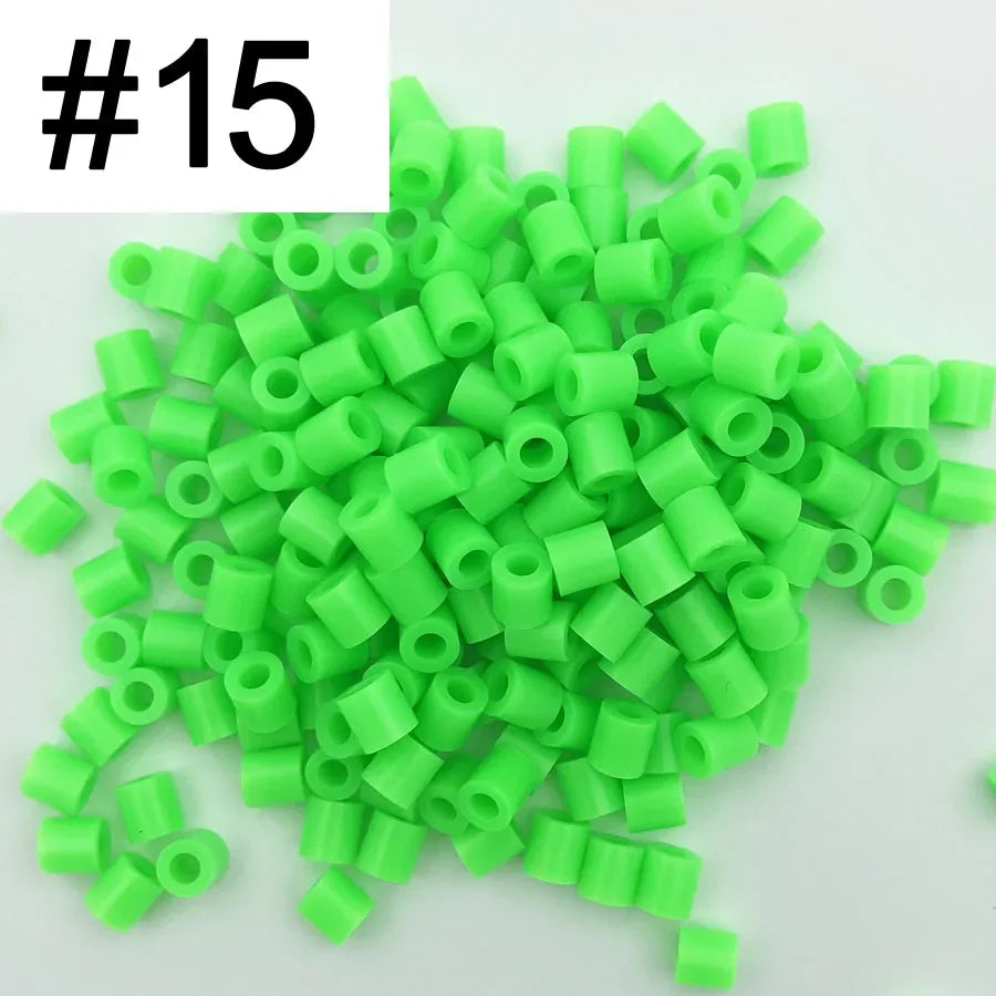 A pile of 1000 small, green plastic fuse beads for creative craft projects.