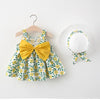 A yellow floral print baby girl summer dress and sunhat set with bow details displayed on a hanger.